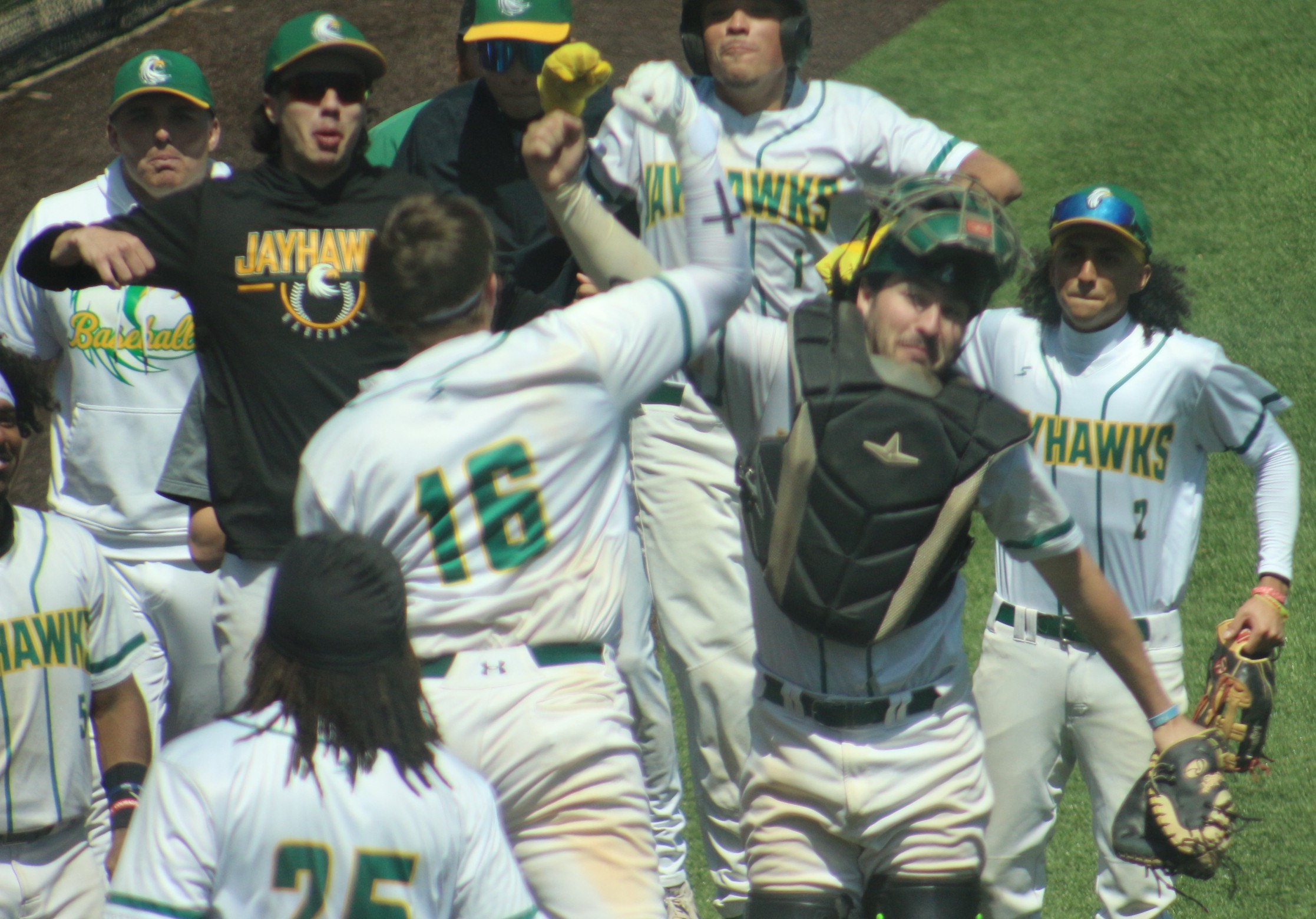 JCC celebrates a grand slam hit by #16 Luke Larson