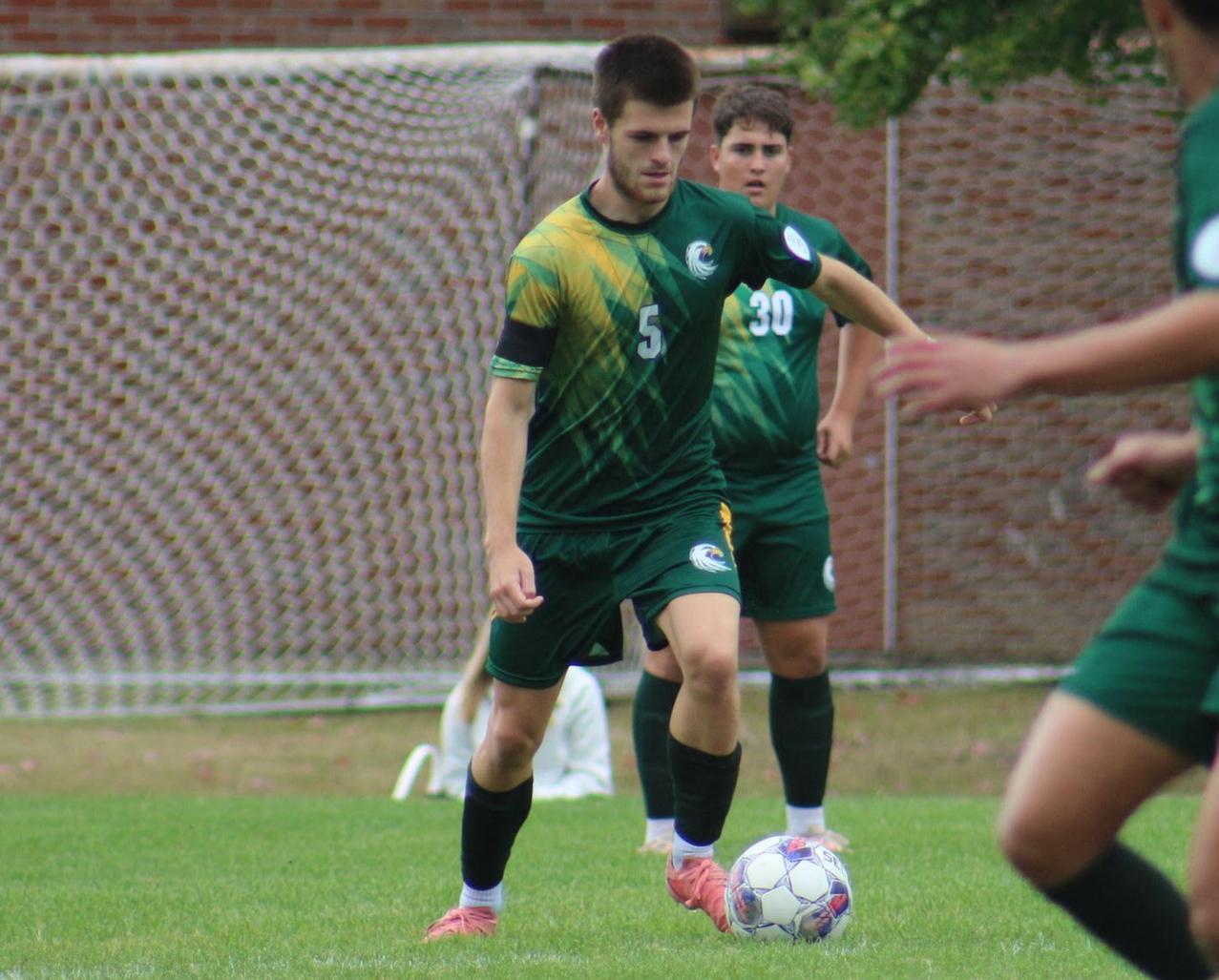 Sam Little playing a ball for JCC in a home soccer match
